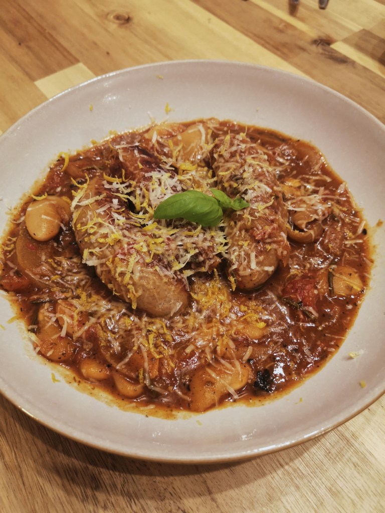 A sausage and bean stew with grated parmesan over the top
