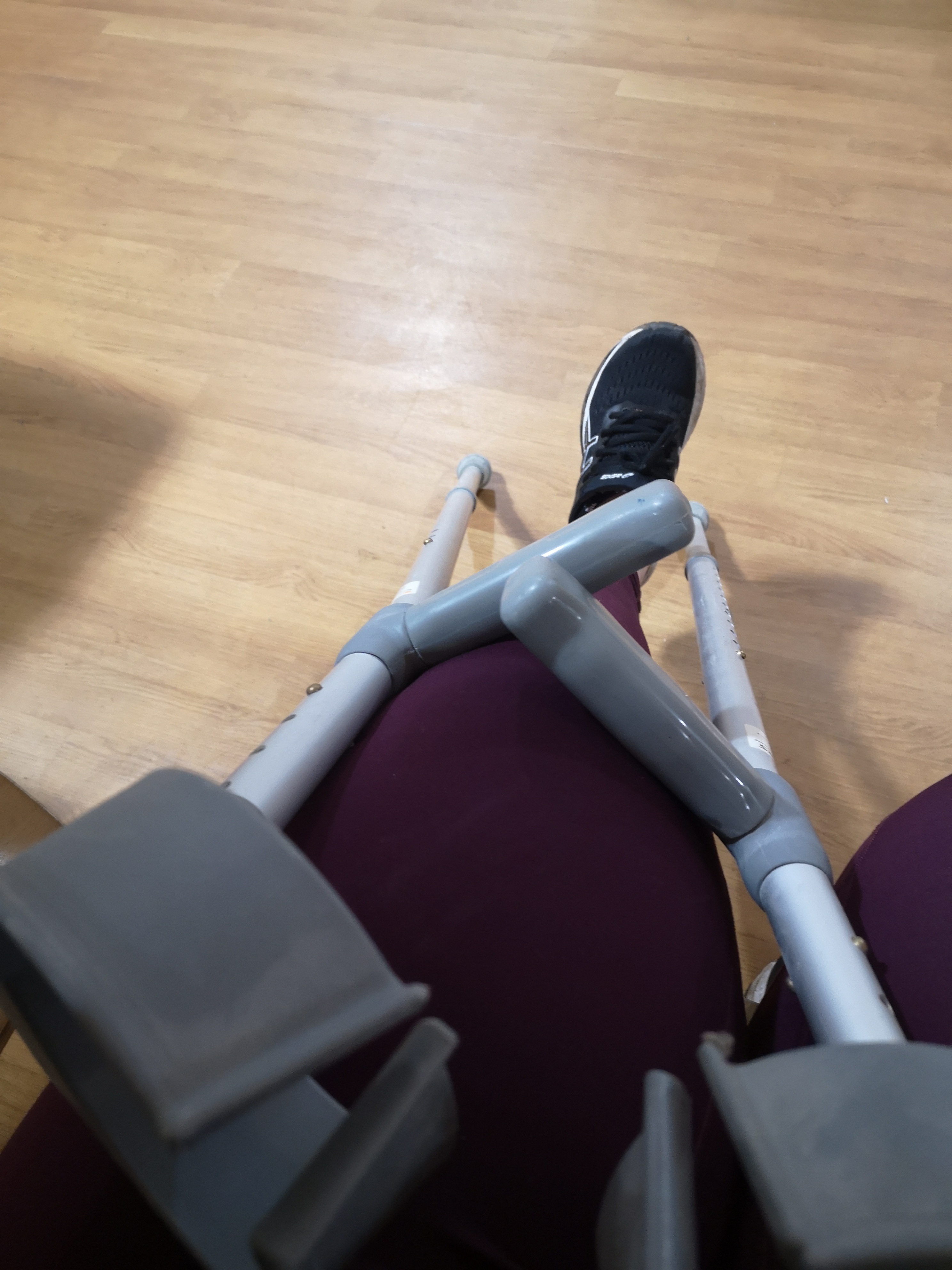 A leg resting with two crutches beside it