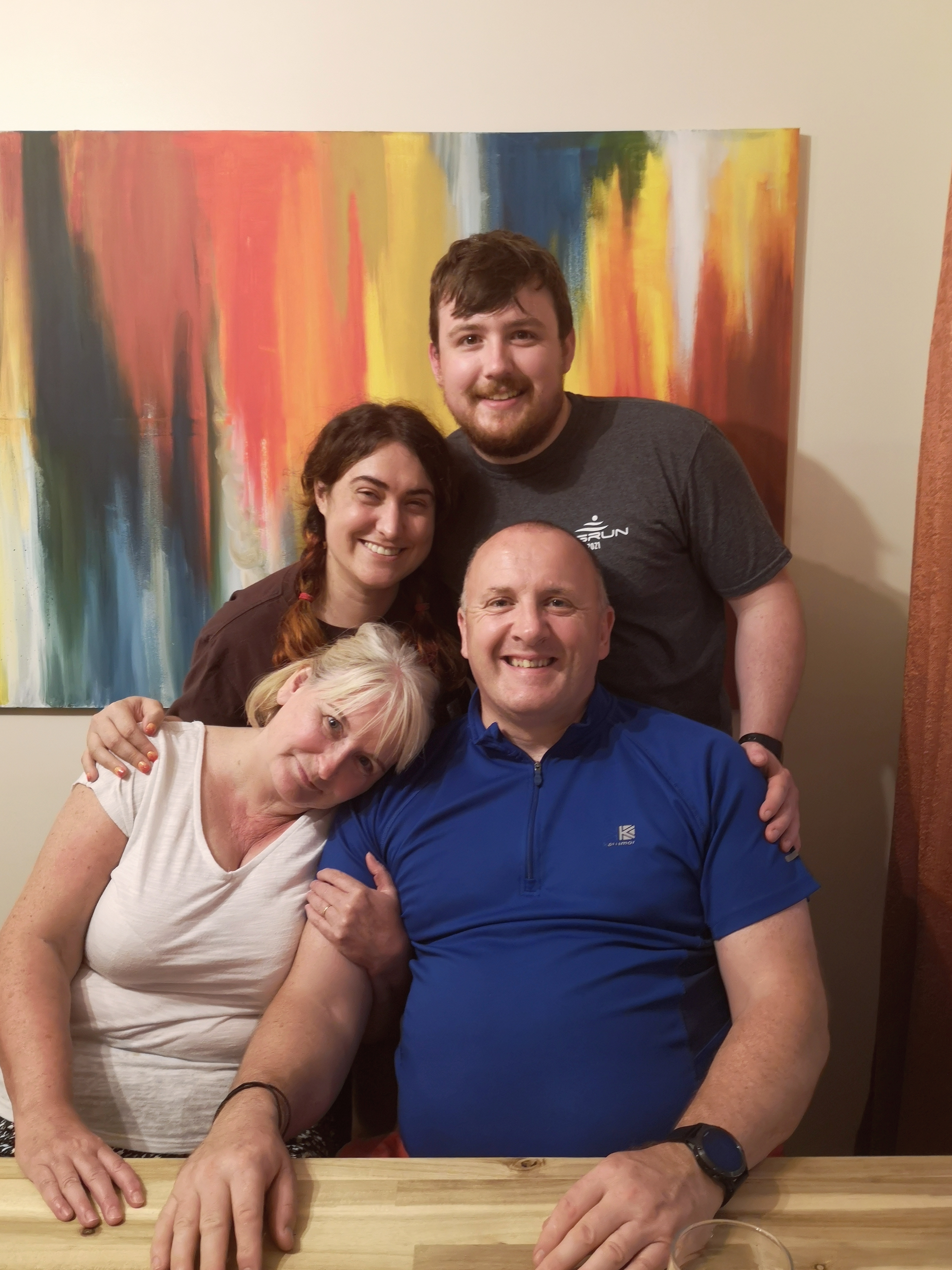 My parents, brother and his girlfriend smile together