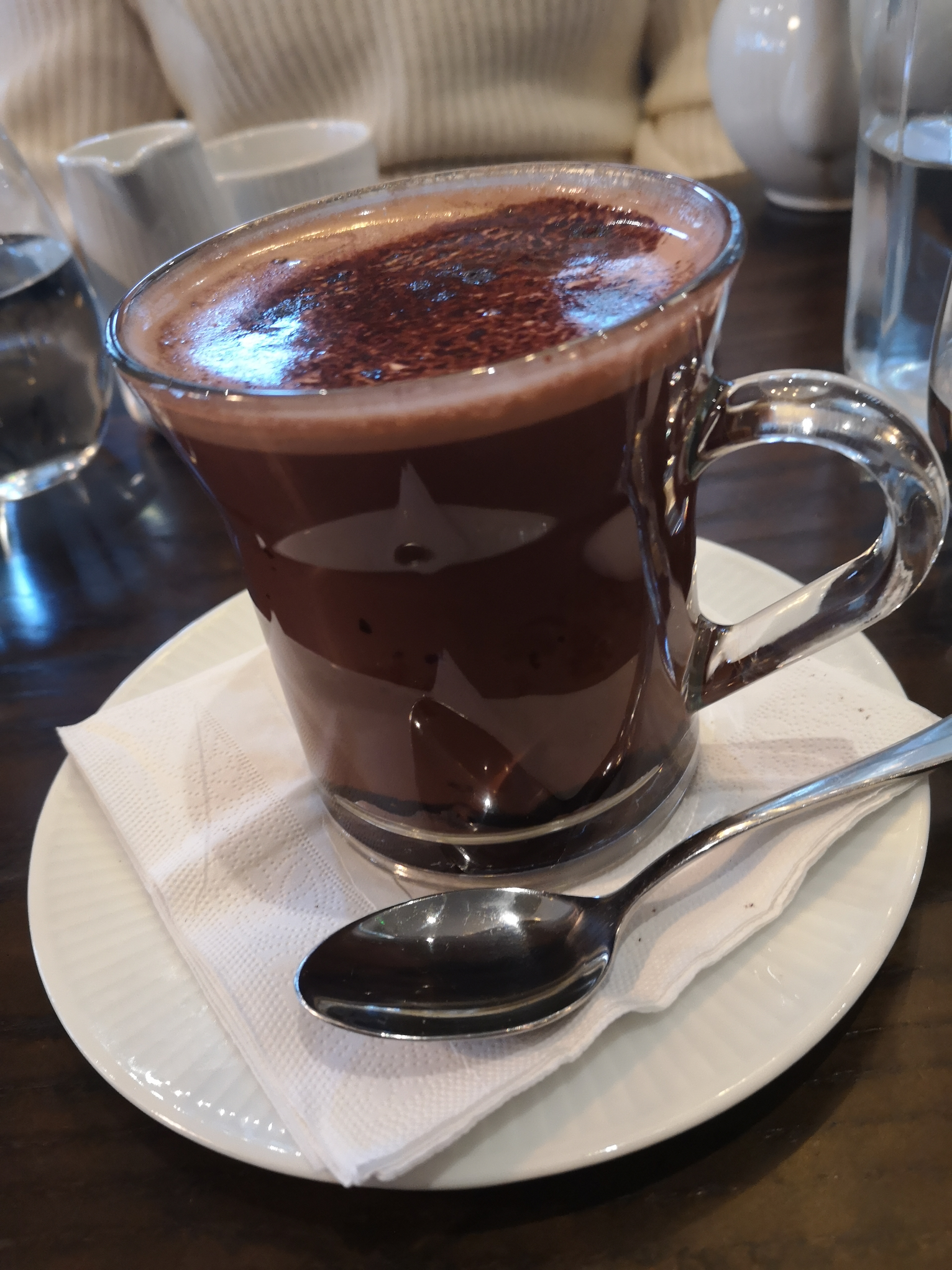 A glass mug of rich hot chocolate