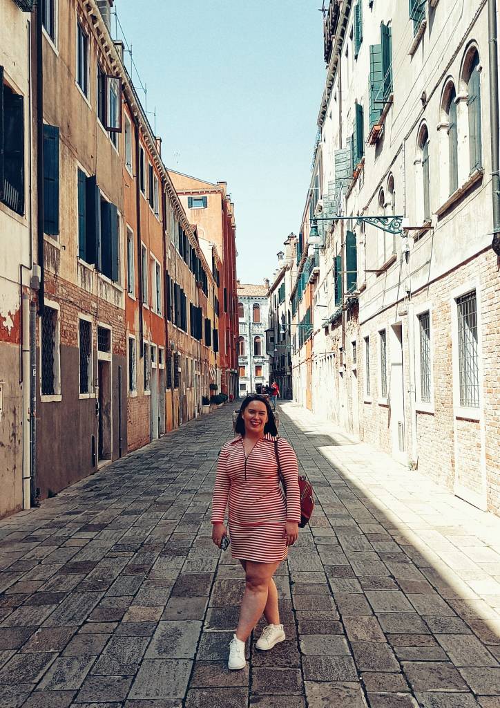Me standing on a cute Venice street. I'm wearing a cute red and white striped dress