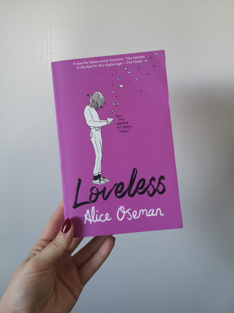 A purple book with a black and white illustration of a girl holding a loveheart in her hand and many little love hearts floating out of it as she looks down at her hands