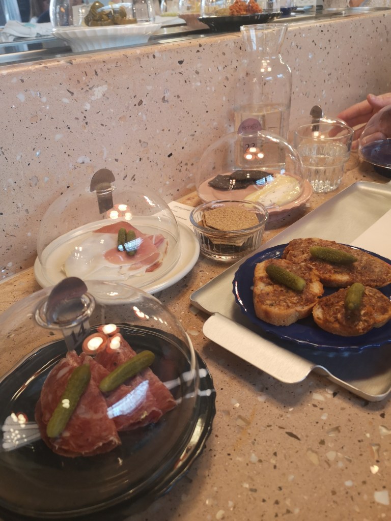 Charceuterie dishes on a table, meats, chesse and bread