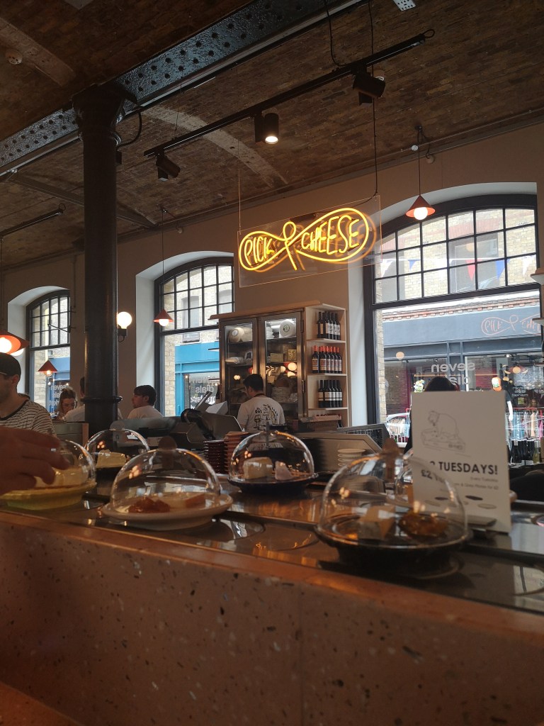 A conveyor belt with little dishes of cheese!