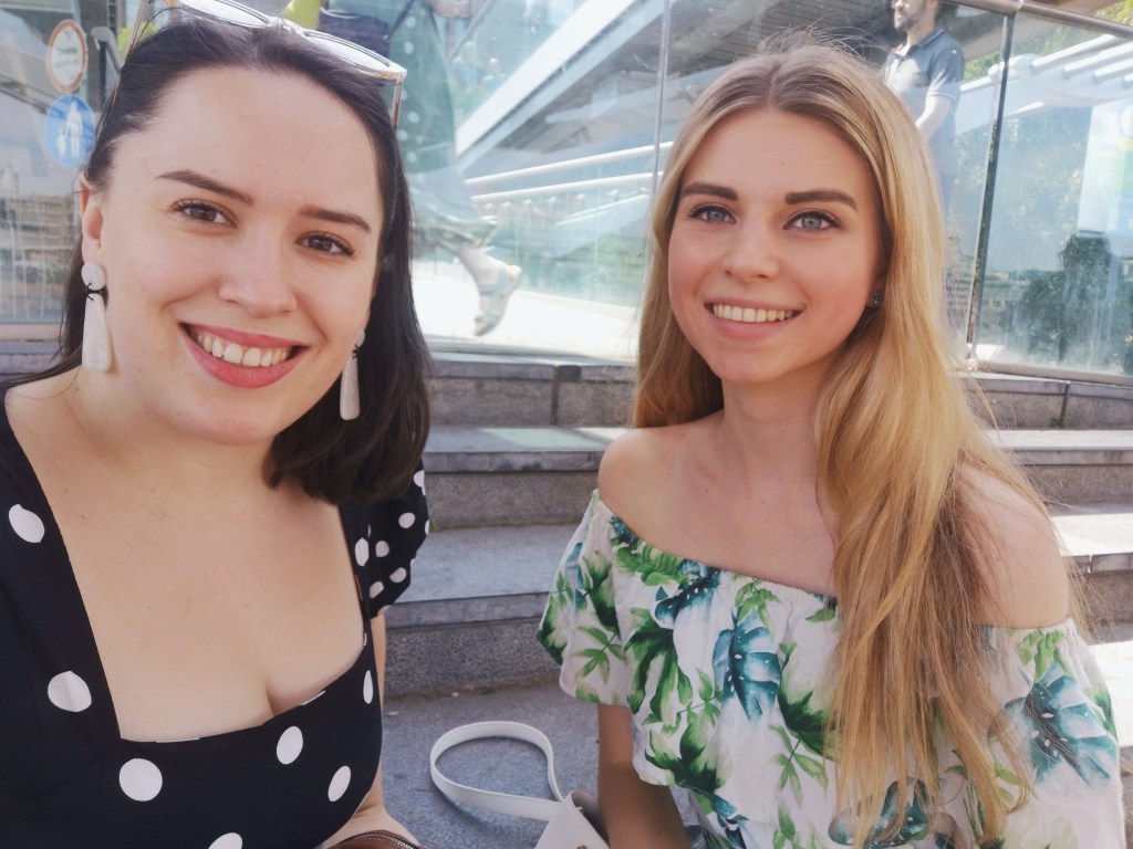 Another two gals smiling together in the sunshine