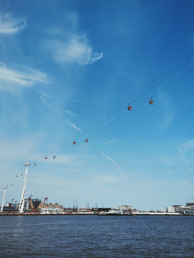 Cable cars up in the blue sky above the river