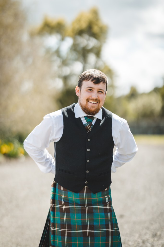 My gorgeous brother is smiling, wearing his lovely kilt
