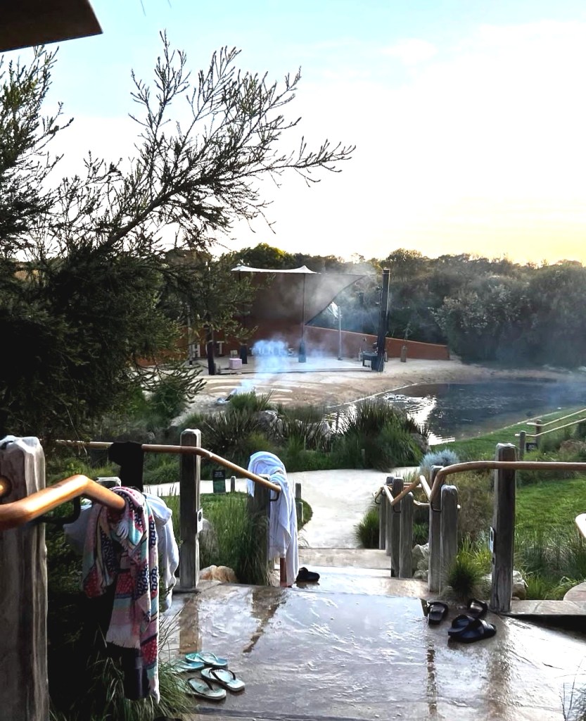 Steam rises off of warm pools and towels, dressing gowns and flip flops wait for people to reclaim them