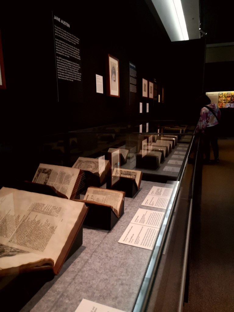 Cases of old books are held open in exhibition