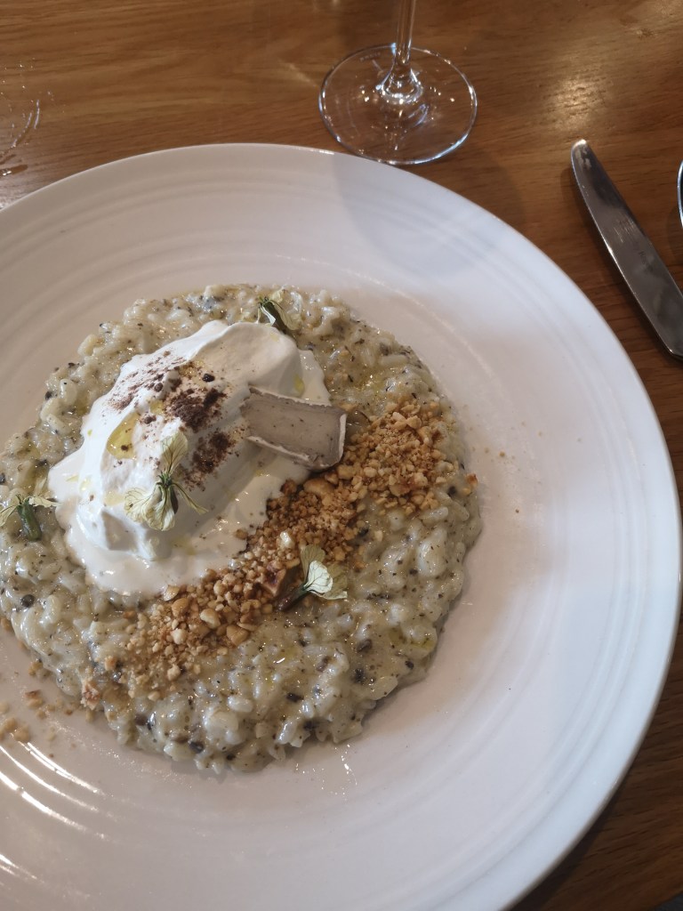 Delicious risotto topped with soft white cheese and chopped nuts
