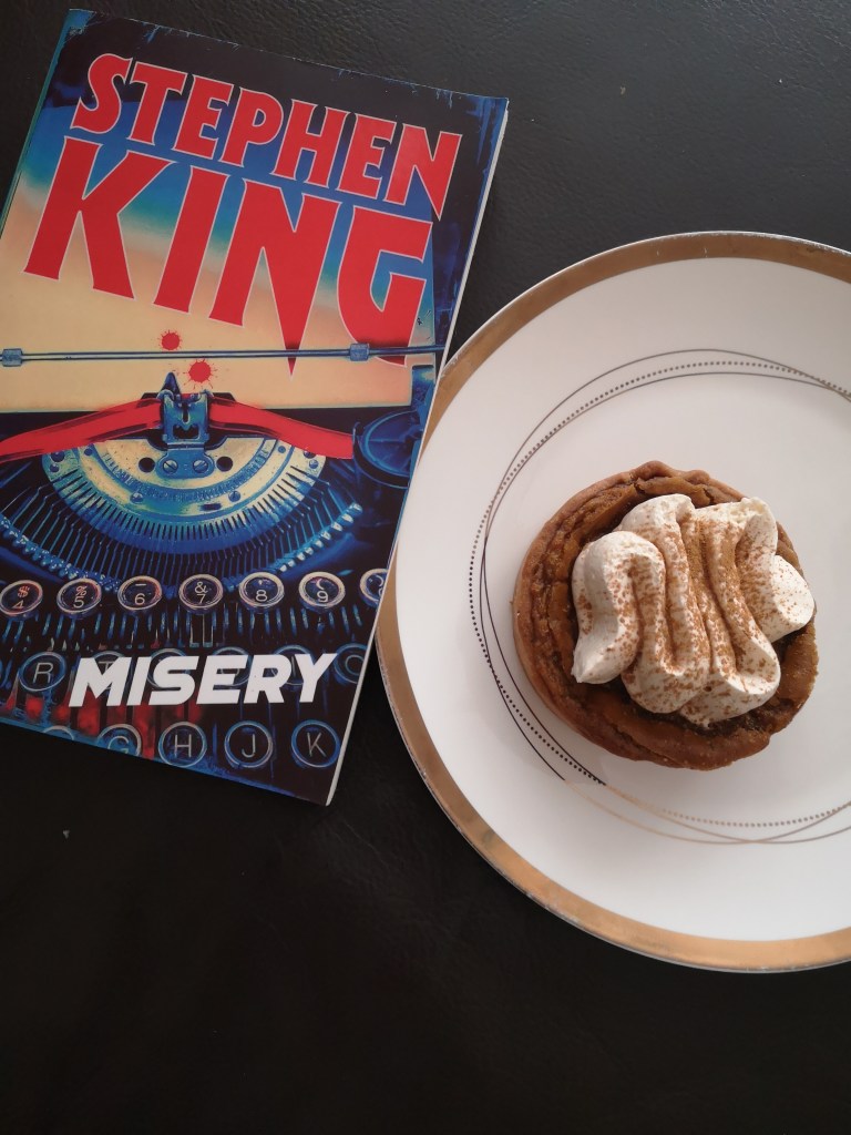 A copy of Stephen King's Misery with a bloody typewriter on the cover