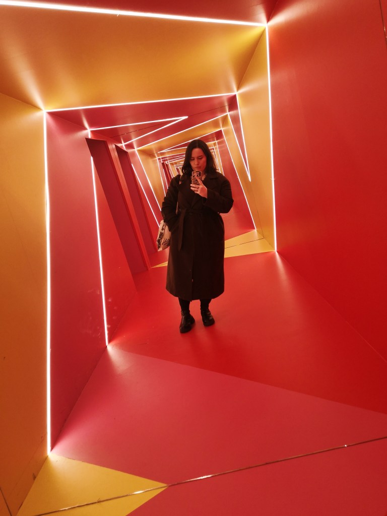 I take a mirror selfie in a squint room