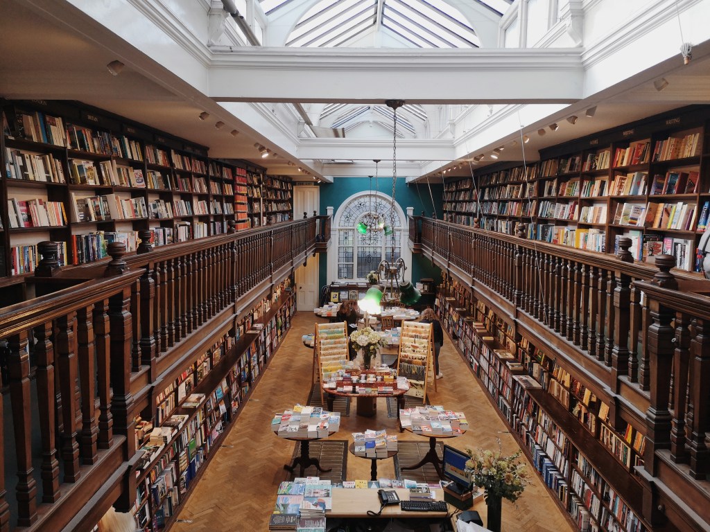 A gorgeous bookshop over two levels with books lining the walls 