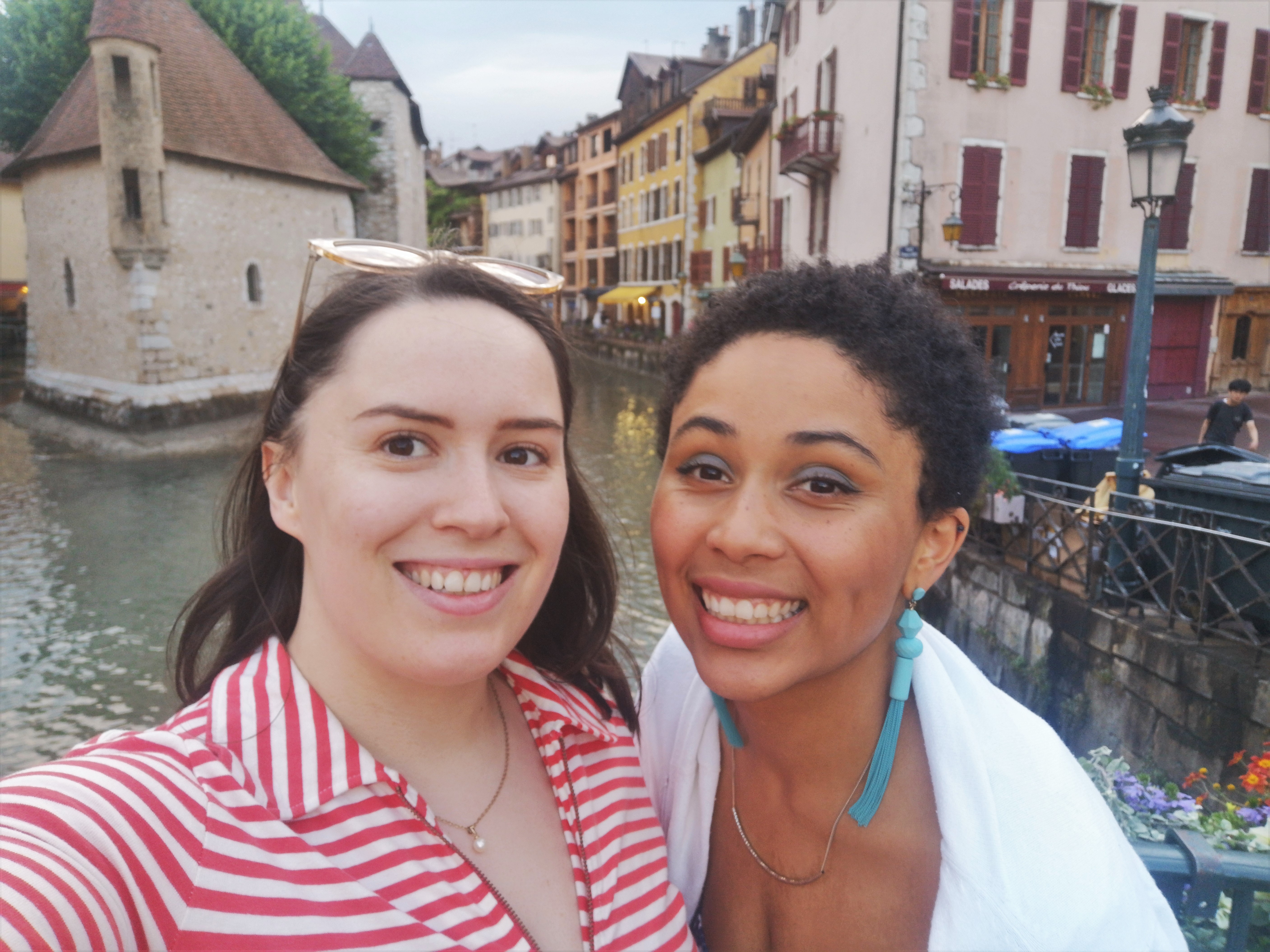 Danielle and I smile for a selfie in front of cute colourful buildings that line the canal