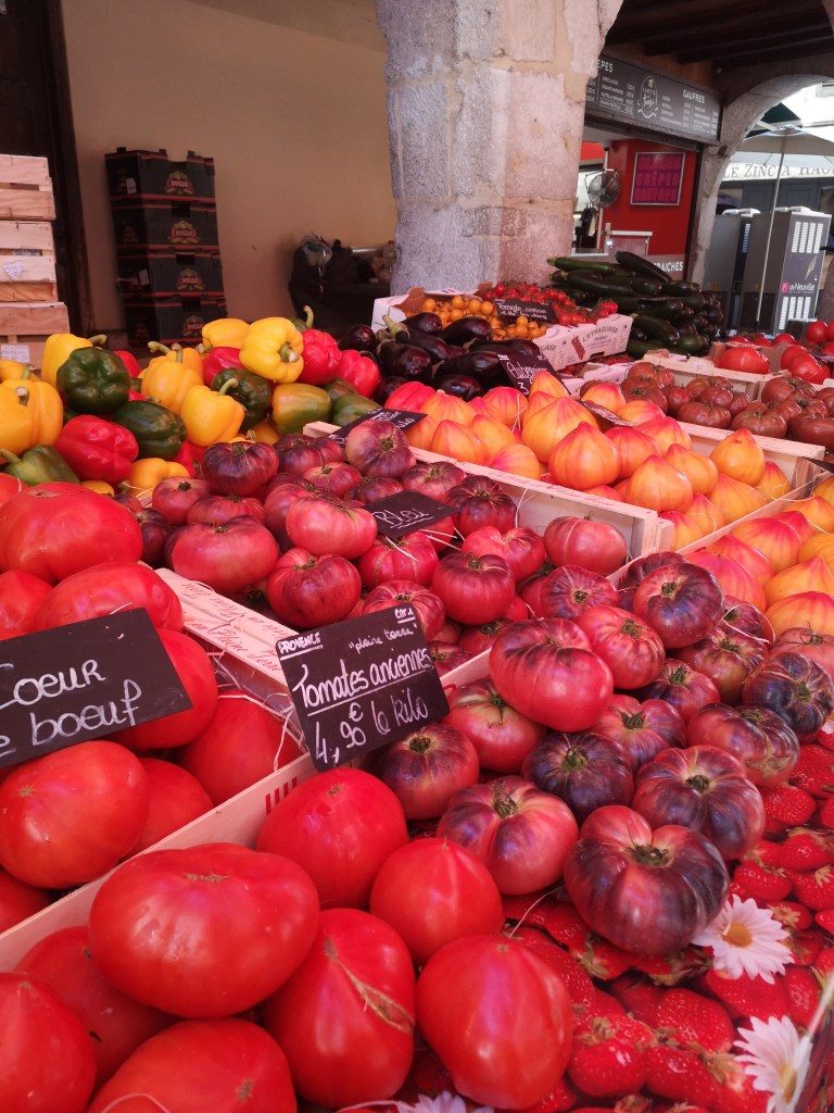 A market stall stacked with loads of tomatoes