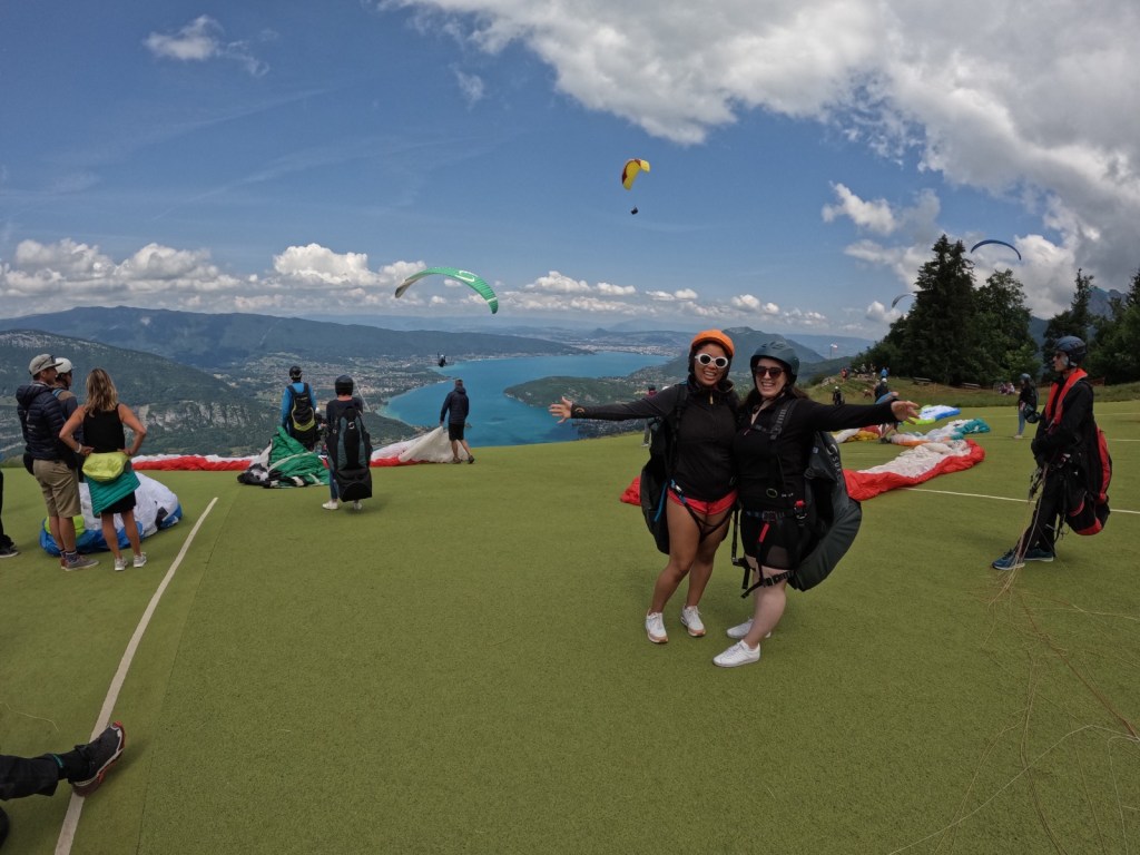 Danielle and I stand on a platform above the lake with our arms outstretched