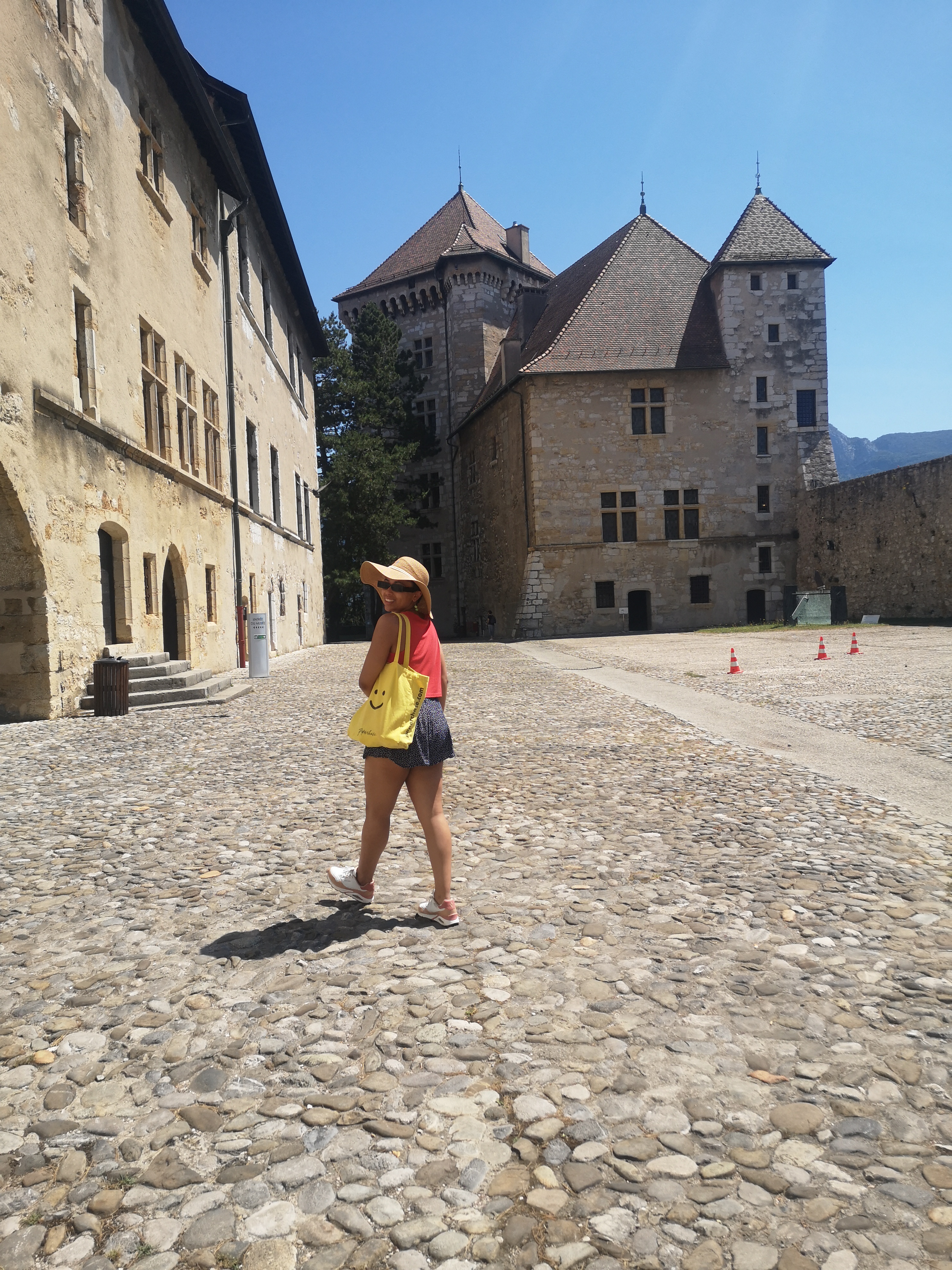 Danielle looks over her shoulder and smiles at me while walking through a castle courtyard