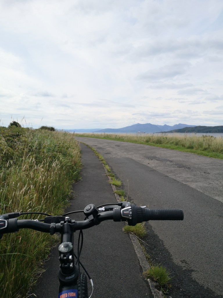 Bike handlebars look out at the road along the sea