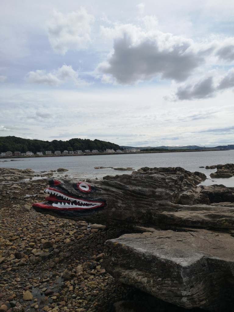 A long pointy painted like a crocodile with jaggy teeth