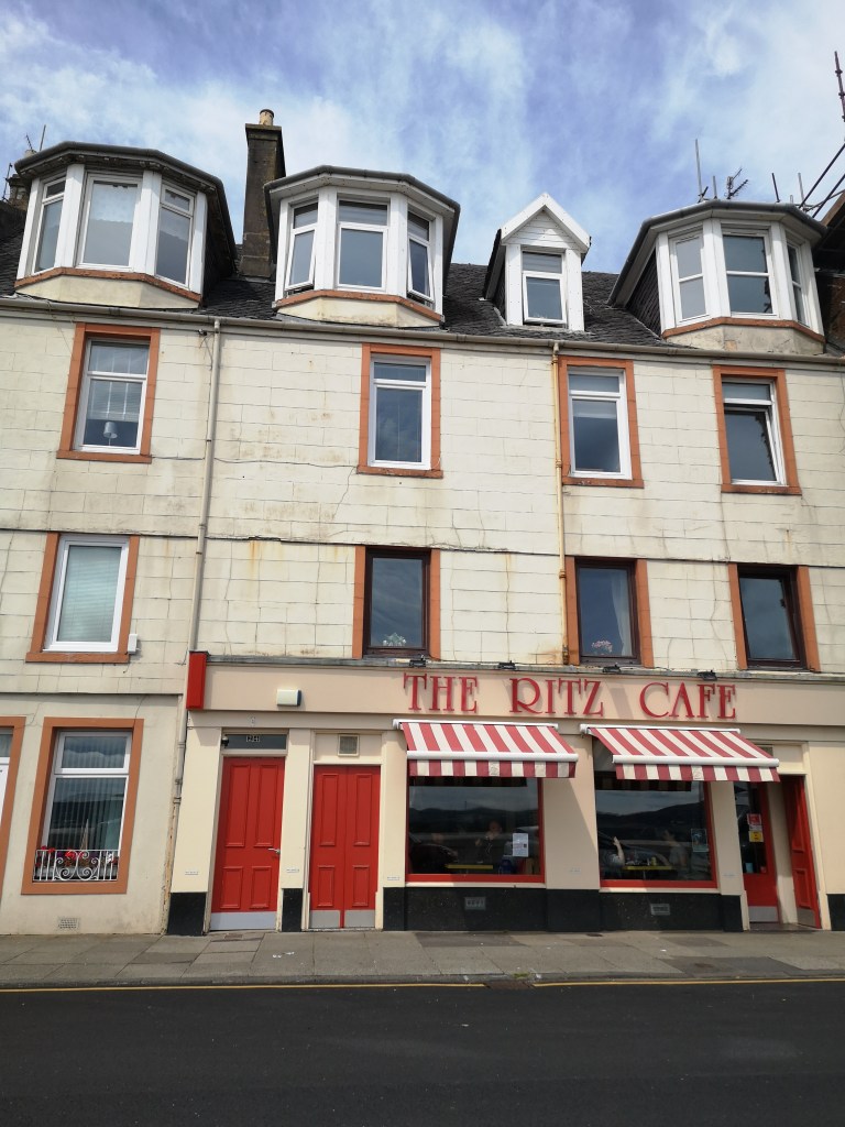 The outside of The Ritz Café with red and white striped canopies