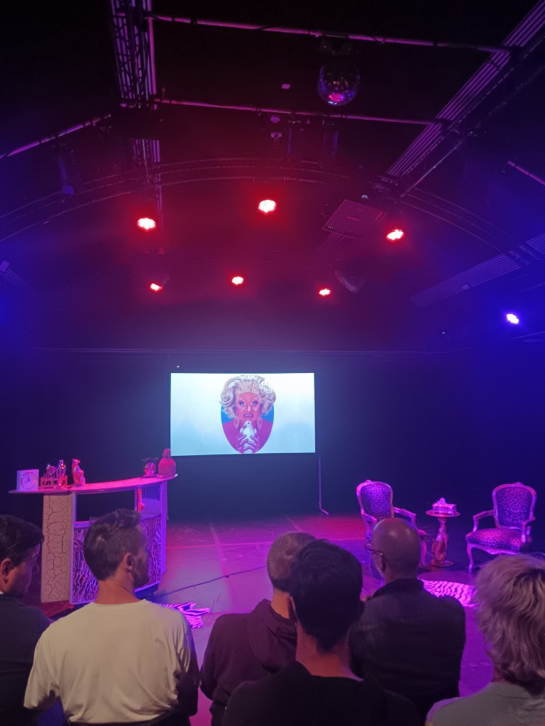 A picture of a drag queen on a screen