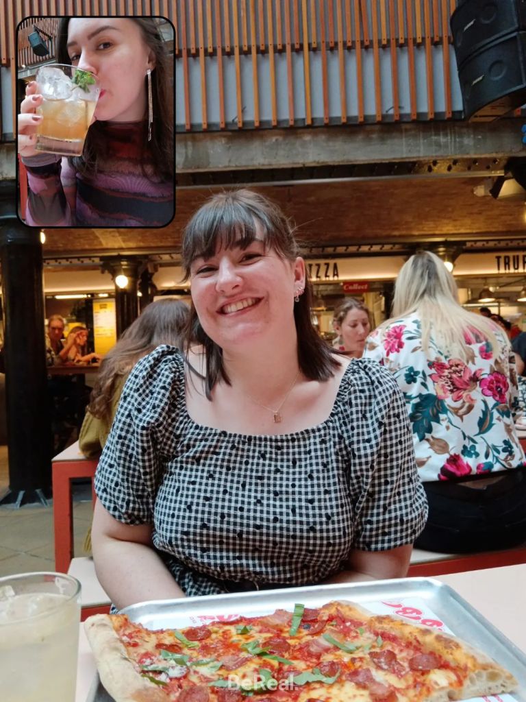 Erin smiles as I sip a cocktail