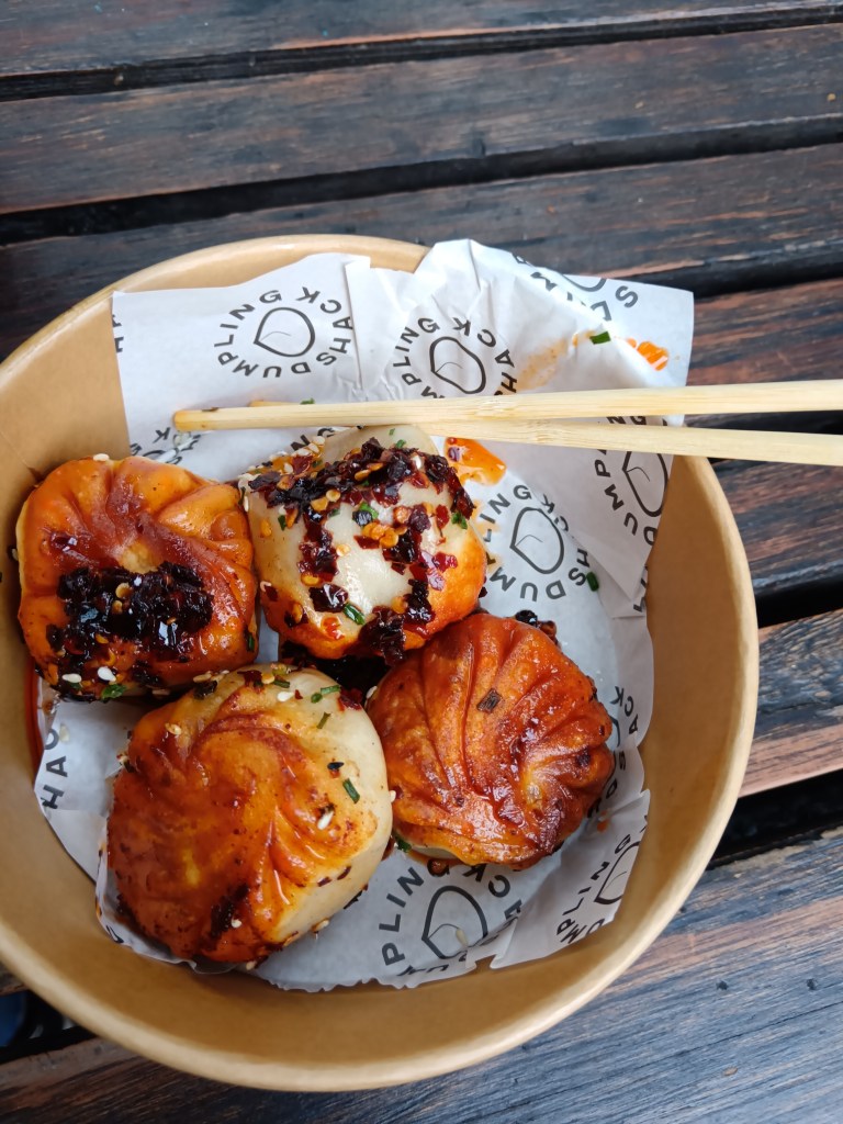 A bowl of golden soup dumplings