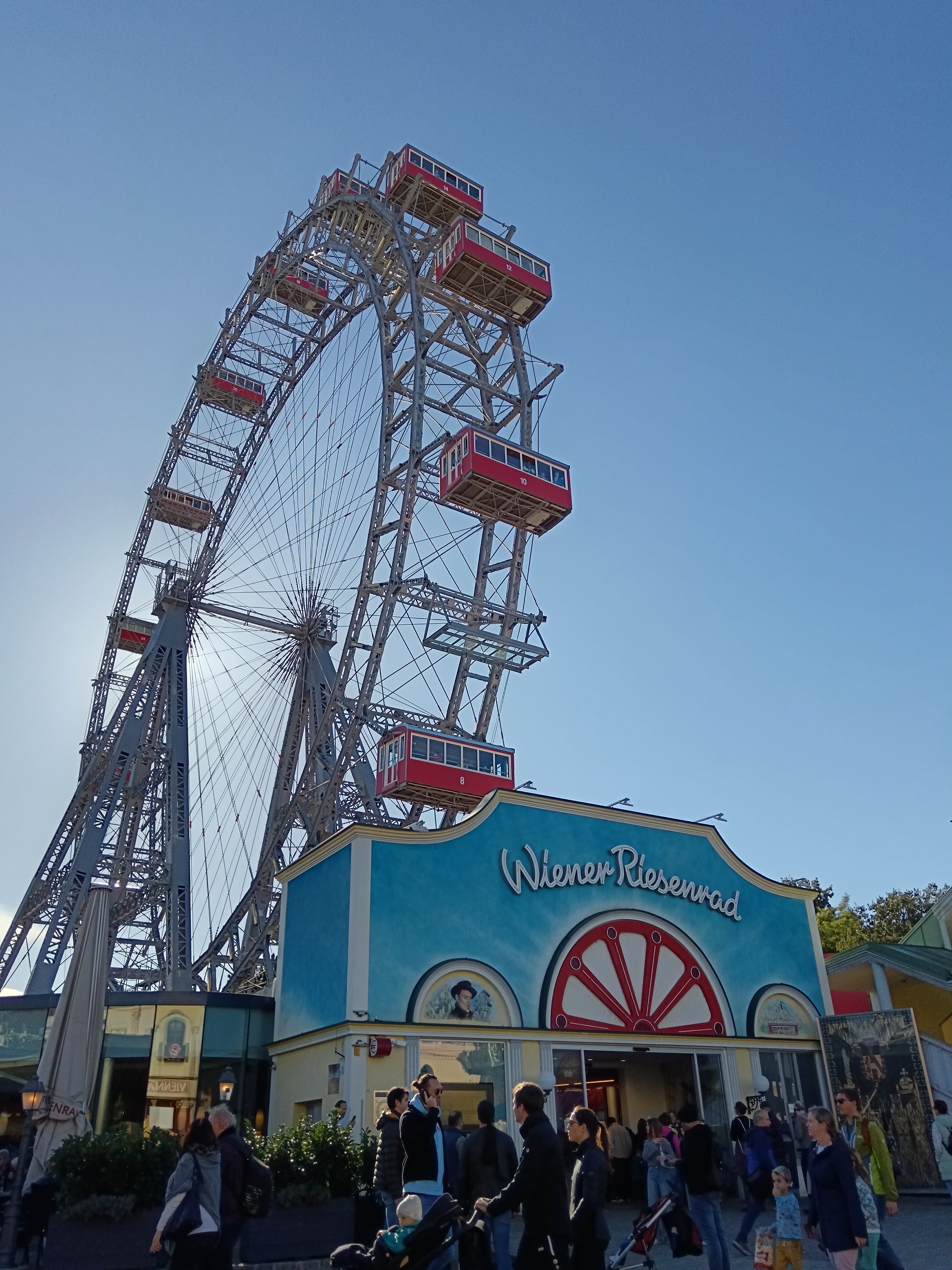A big ferris wheel against a blue sky