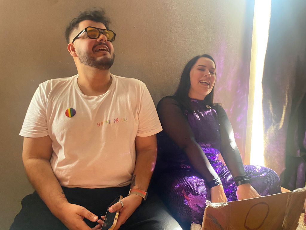 My friend and I lean against a wall and sing 