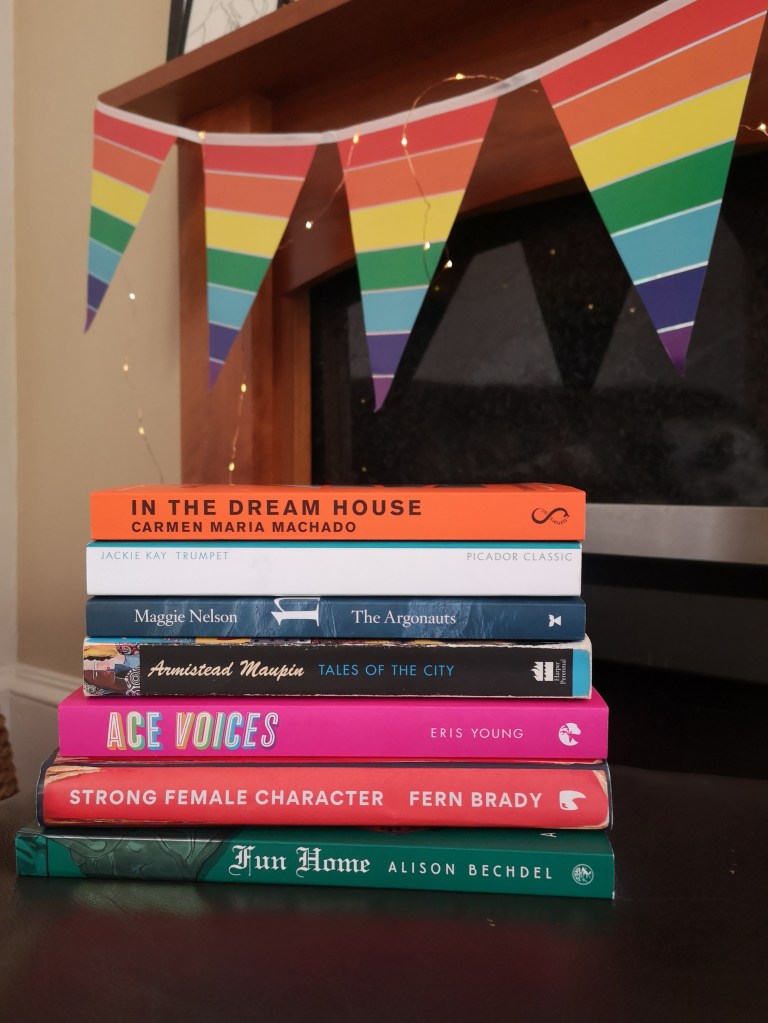 A stack of books with In the Dream House, Trumpet, The Argonauts, Tales of the City, Ace Voices, Strong Female Character and Fun Home