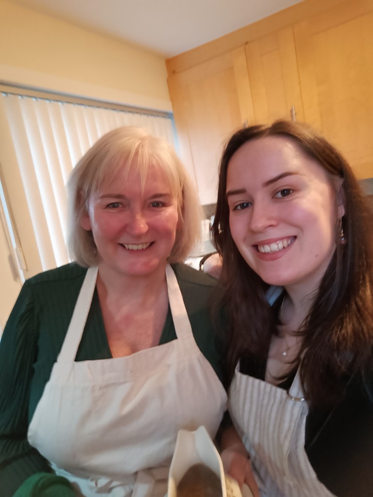 My mum and I smile for a selfie in our cooking aprons