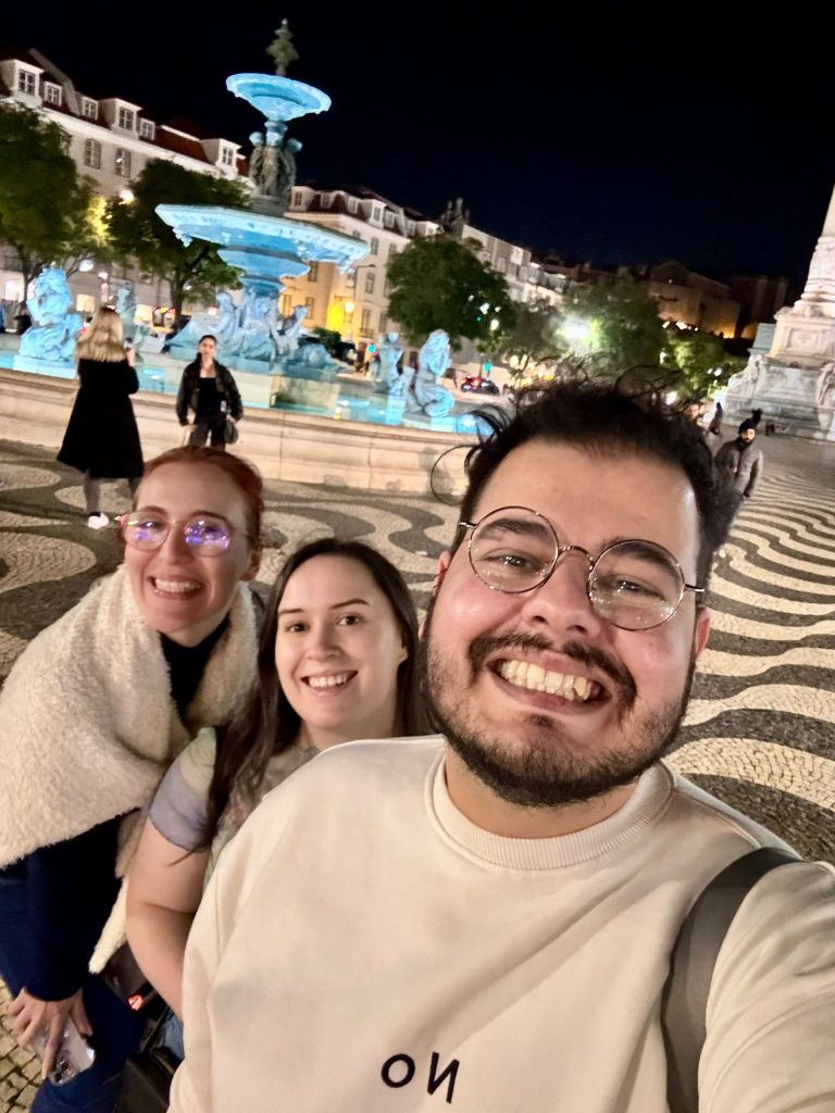 Bruno, Deby and I smile for a selfie in front of a fountain