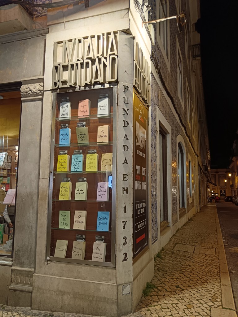 The outside of a bookshop with a display case filled with colourful books