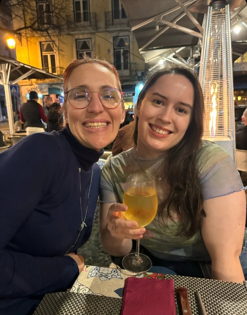 Deby and I smile together and I hold a big glass of wine