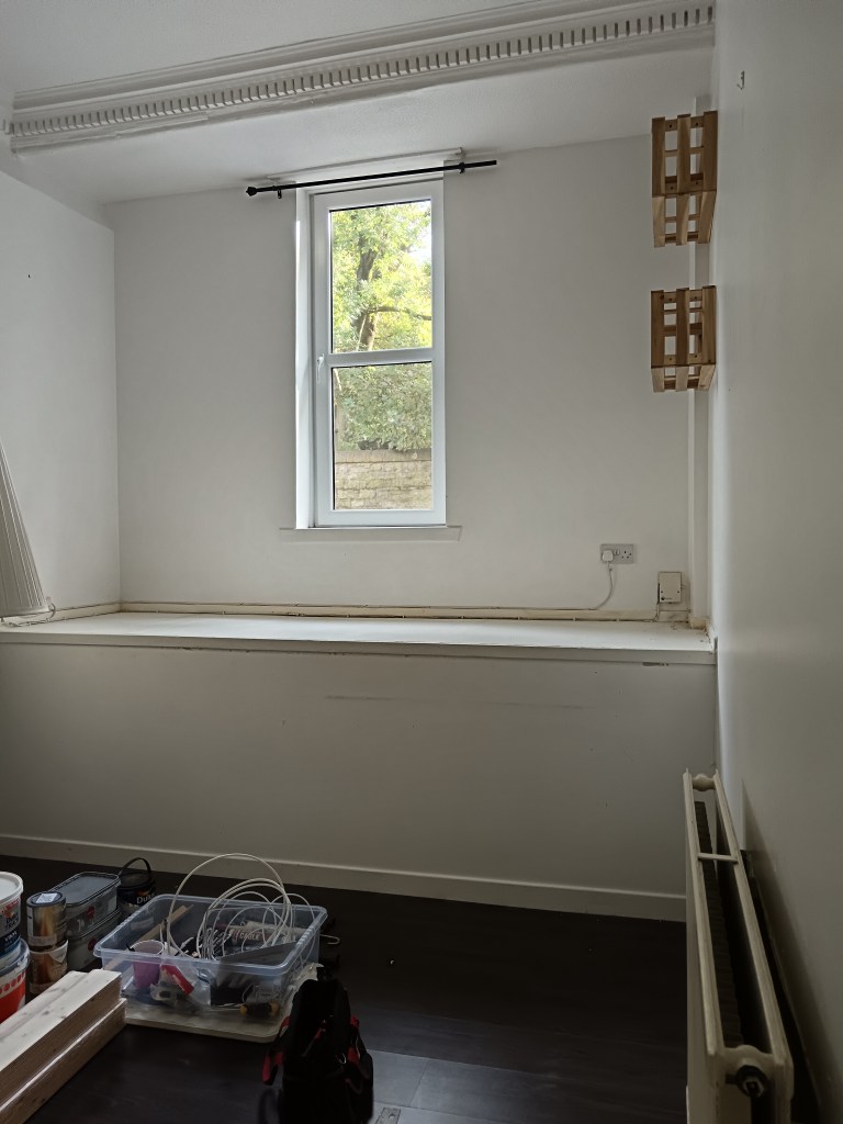 An empty white room with scuff marks on the walls 