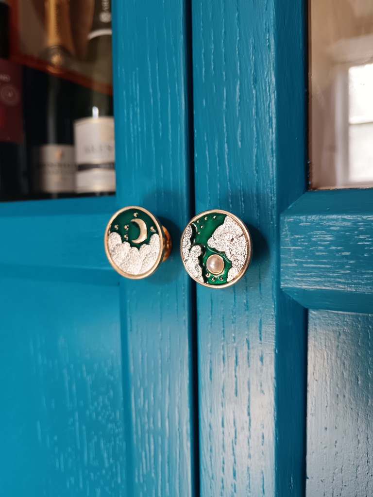 Small gold, pearl and blue door knobs with moons on them