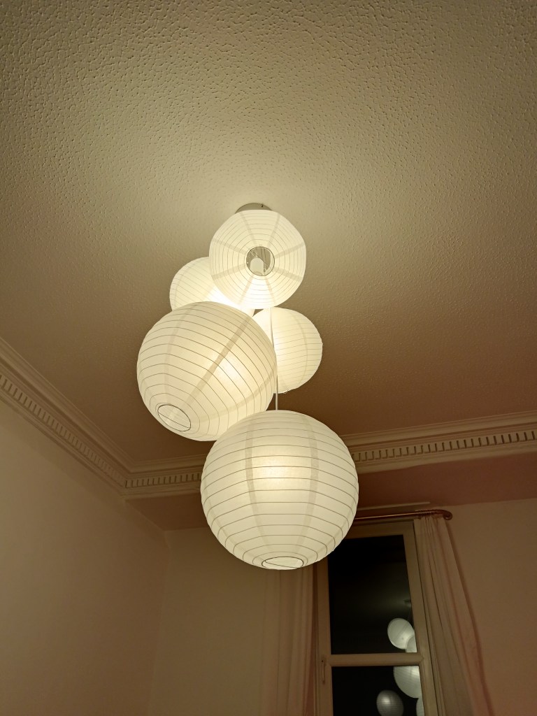 Five papern lanterns hang like a bunch of grapes