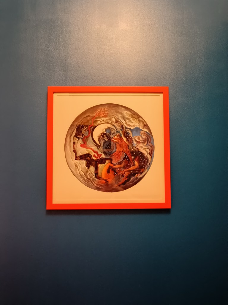 An orange frame with circular art of greek characters
