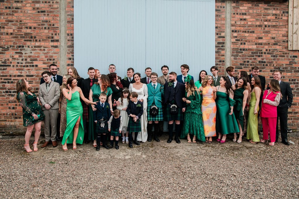 A big group photo with a bunch of wedding guests