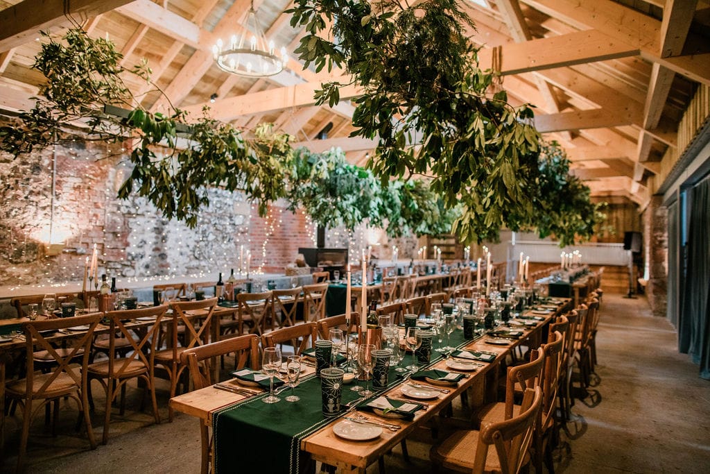 Leaves hand over the top of long dinner tables