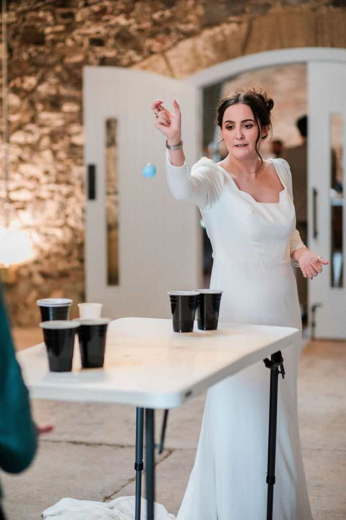 Bride plays beer pong