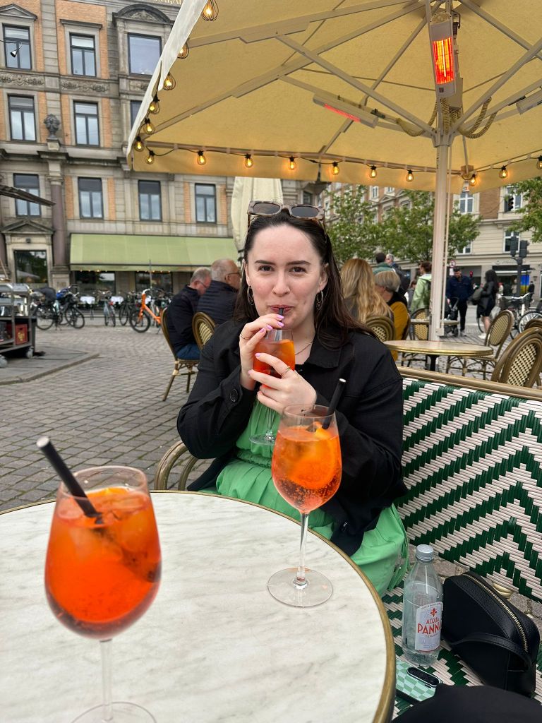 I smile while sipping a spritz