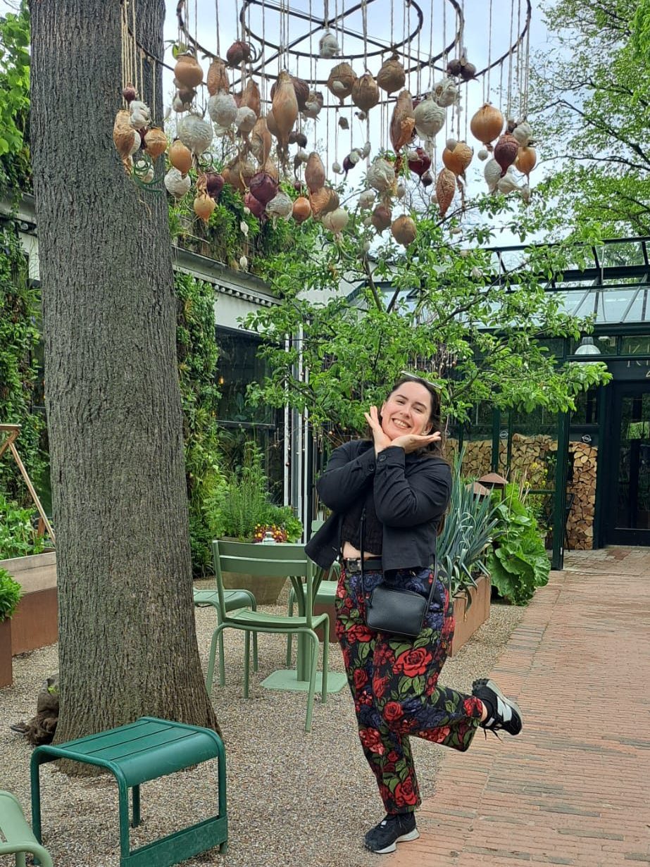 I strike a cute post under a mobile made of onions and garlic