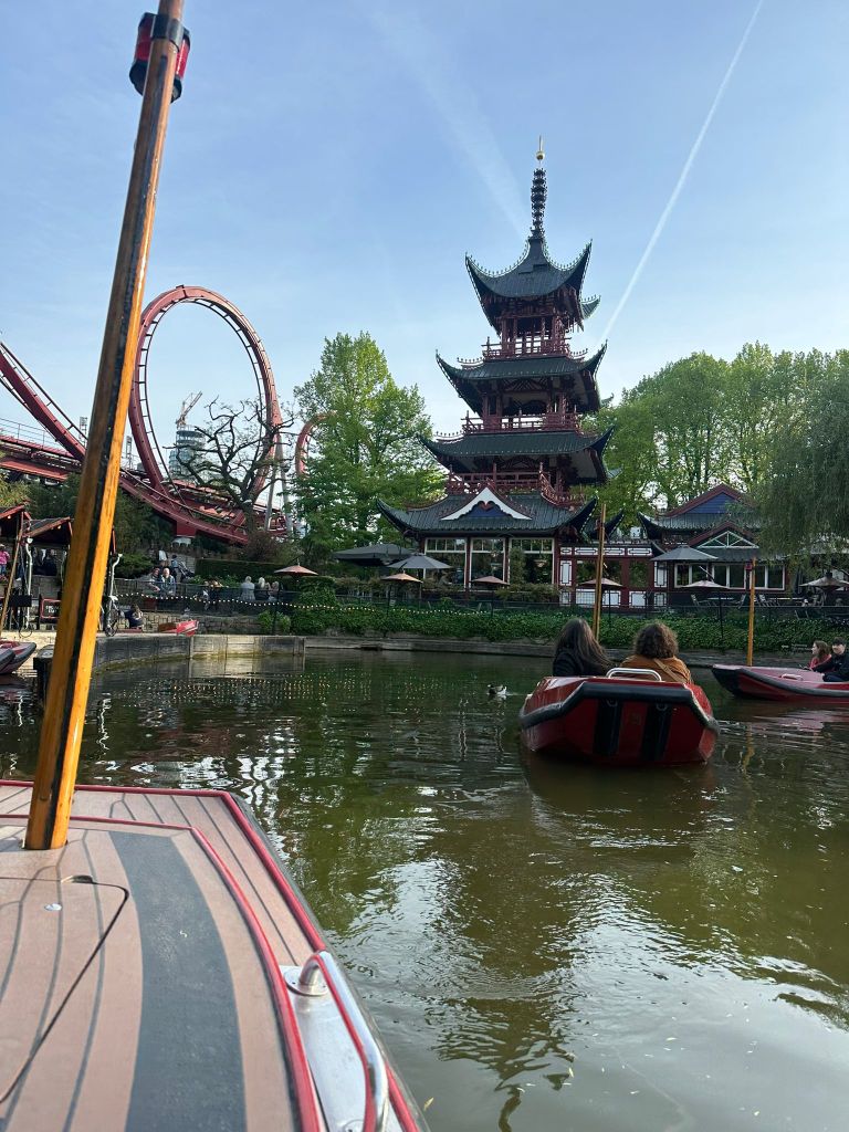 Laura and I sail away on our little boat, the theme park in front of us