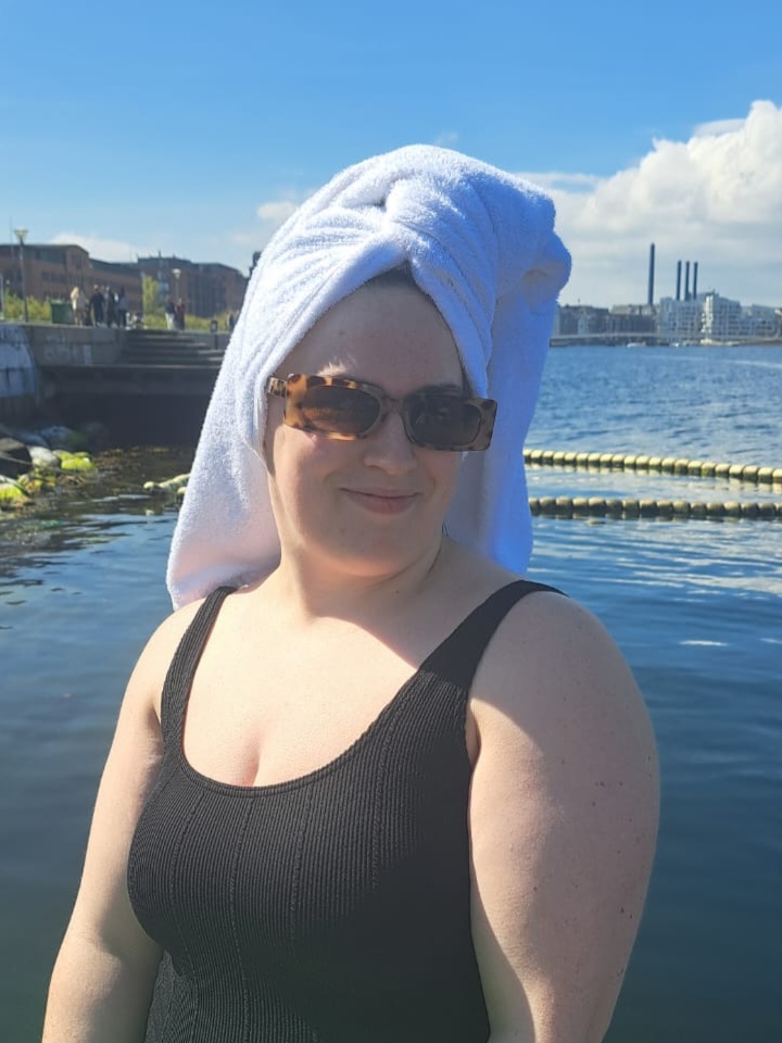 I have a towel on my head and sunglasses on post-swim