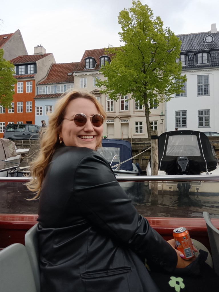 Hanna sits on the boat smiling