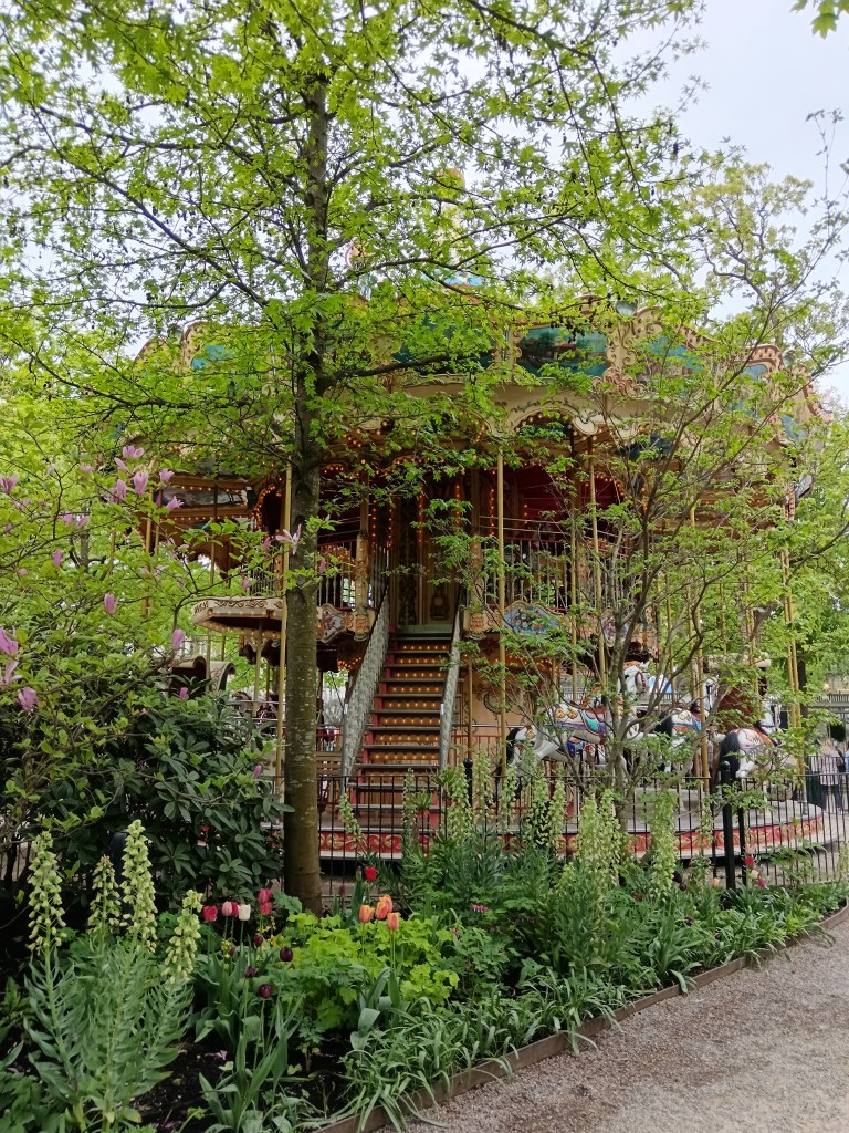 A carousel surrounded by plants