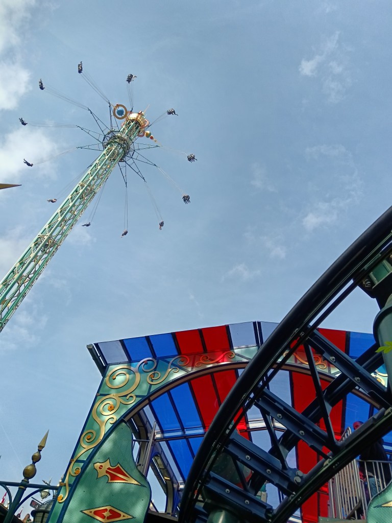 Looking up at a very tall seat swing