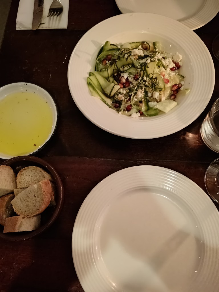 Cucumber salad, bread and oil