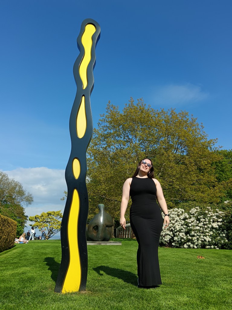 I stand beside a piece of art